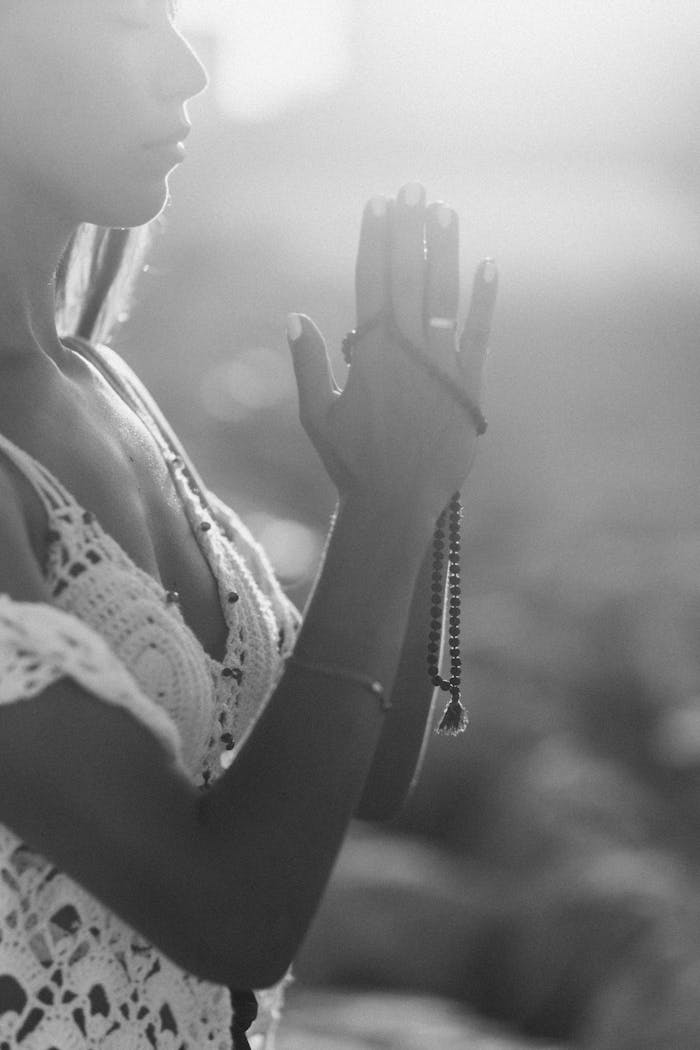 Grayscale Photo of Woman Meditating